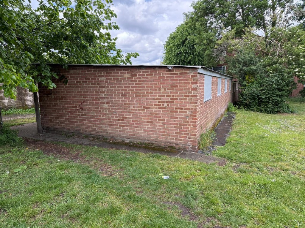 Lot: 19 - NINE FREEHOLD LOCK-UP GARAGES IN CENTRAL LOCATION - View of rear of garages